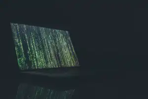 Code on screen in dark room