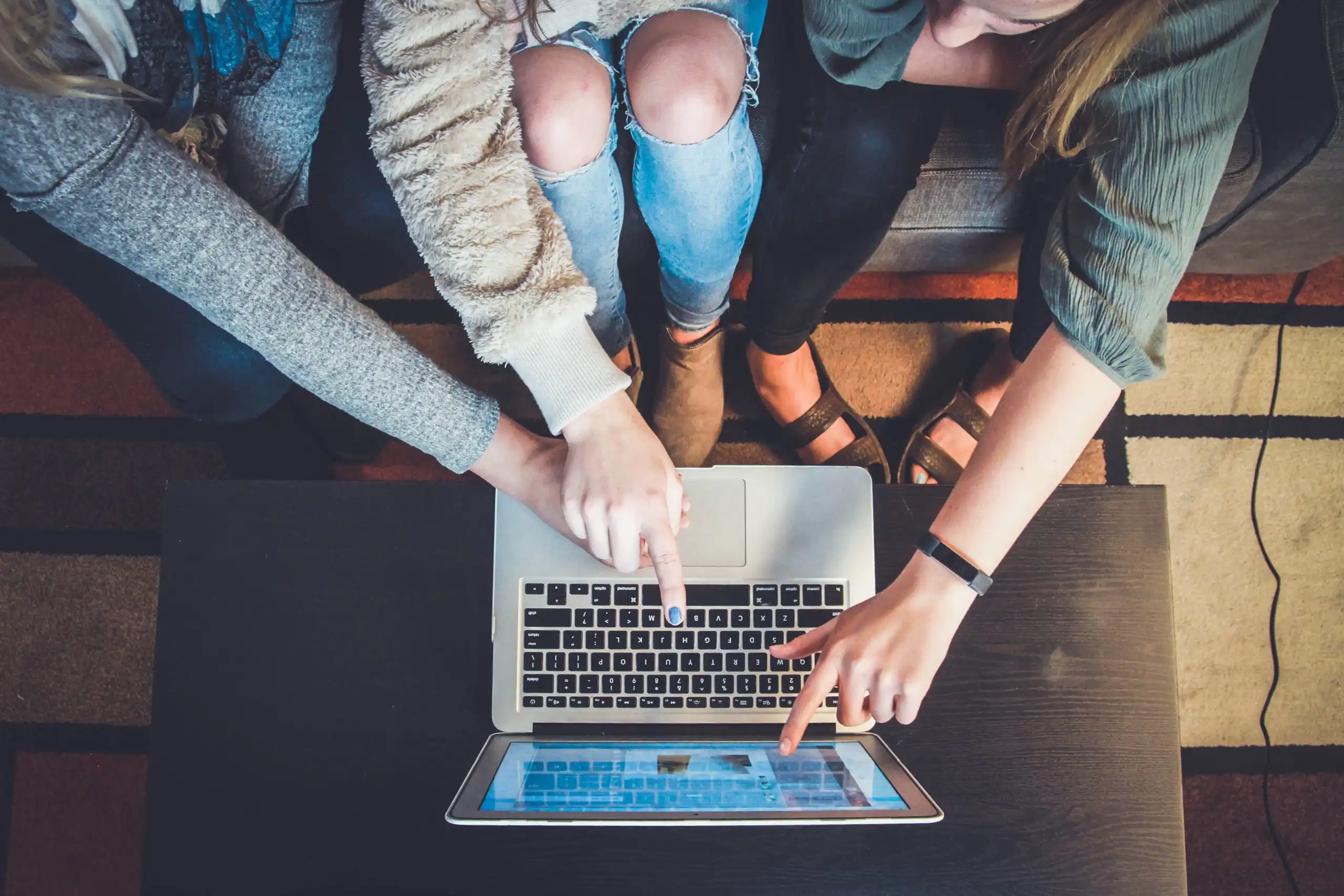 Several women looking at a laptop screen
