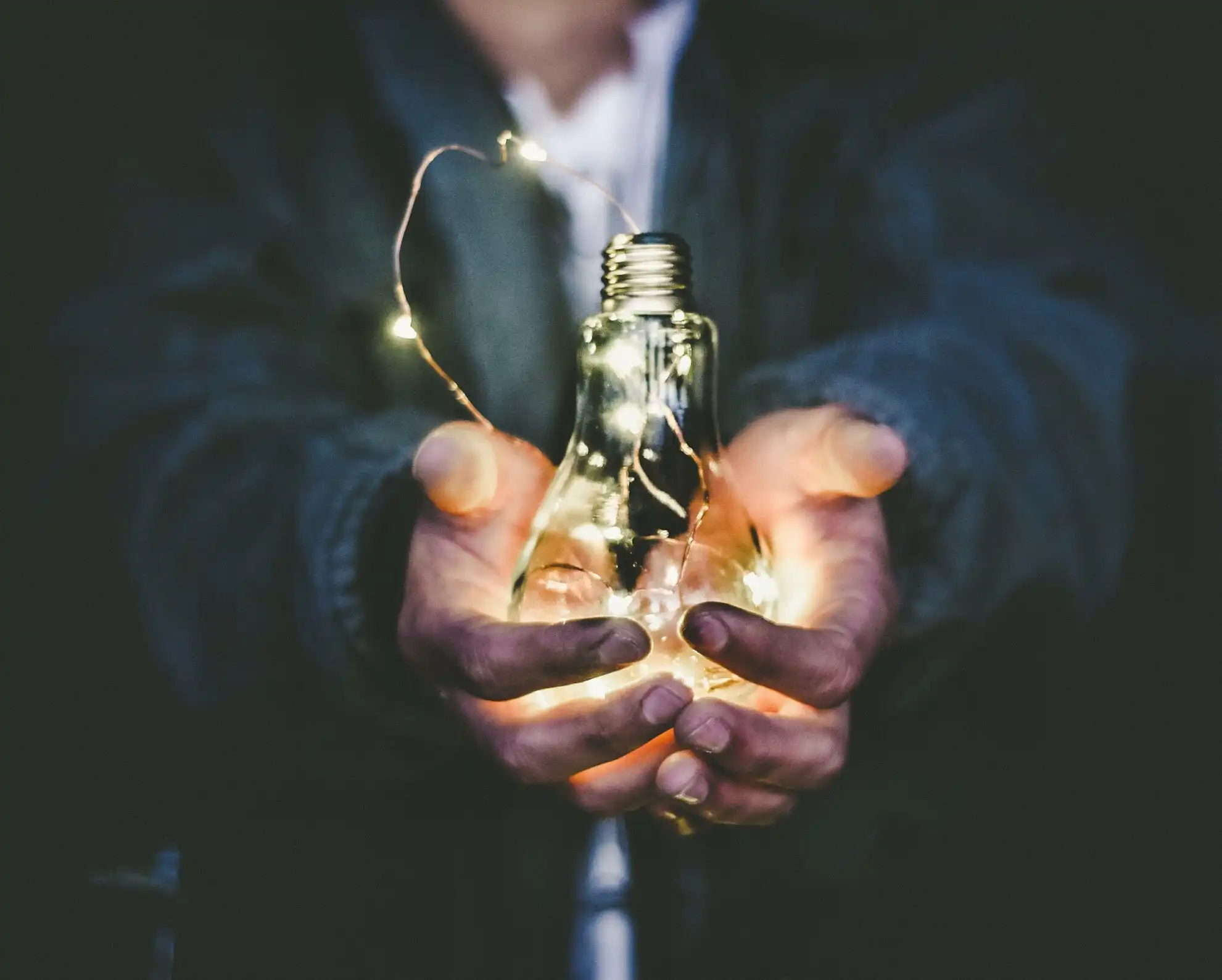 Man holding lighten light bulb in his hands